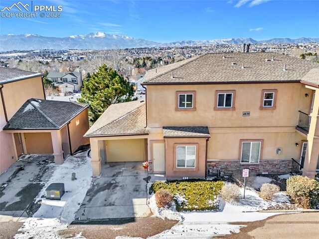 view of front of home featuring a garage and a mountain view