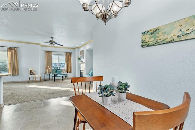 carpeted dining area with ornamental molding and ceiling fan with notable chandelier