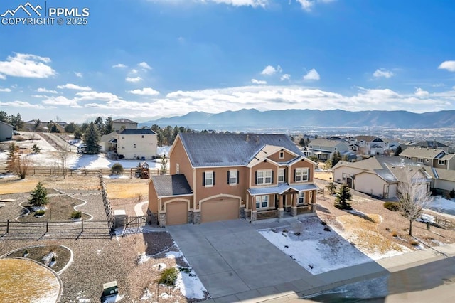 view of front of property featuring a mountain view and a garage