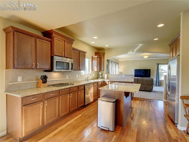 1235 Woodmoor Acres Dr, Monument, CO 80132 - kitchen featuring a kitchen bar, a wealth of natural light, sink, and stainless steel appliances