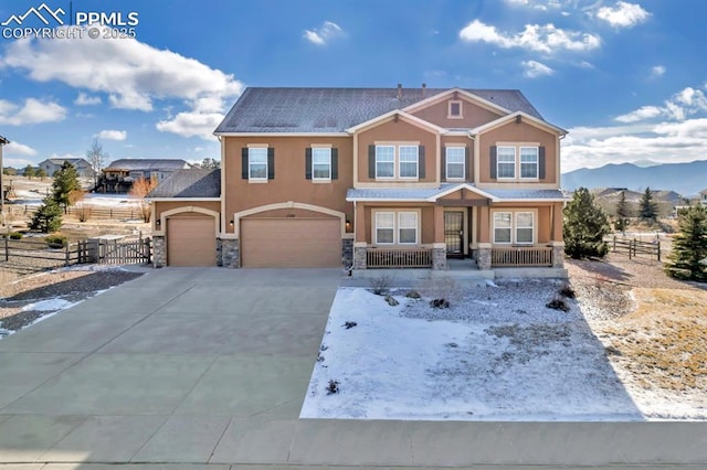 craftsman house with a mountain view, covered porch, and a garage