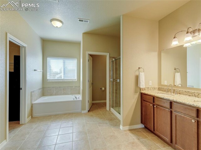 1235 Woodmoor Acres Dr, Monument, CO 80132 - bathroom with tile patterned flooring, vanity, and separate shower and tub