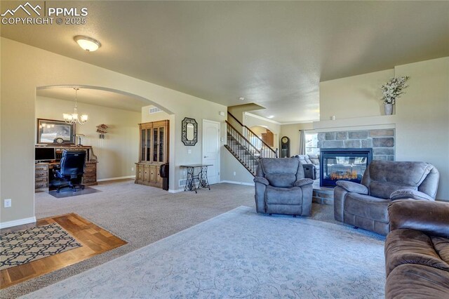 1235 Woodmoor Acres Dr, Monument, CO 80132 - carpeted living room with a tile fireplace and a chandelier