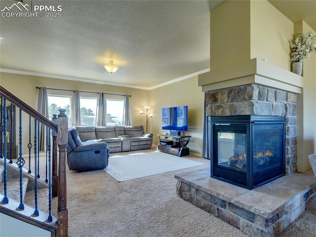 1235 Woodmoor Acres Dr, Monument, CO 80132 - carpeted living room featuring a stone fireplace, a textured ceiling, and ornamental molding