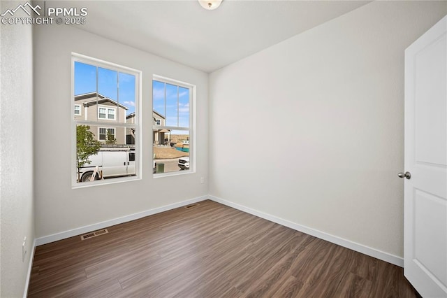 spare room with hardwood / wood-style flooring