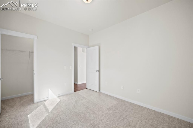 unfurnished bedroom with carpet floors and a closet