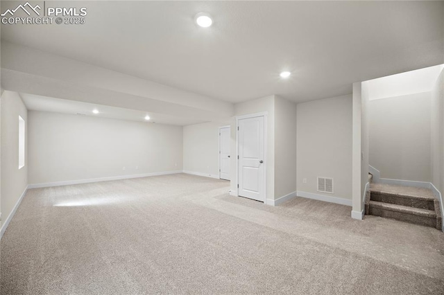 basement featuring light carpet