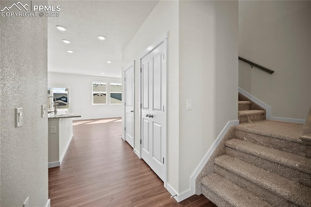 corridor with hardwood / wood-style floors