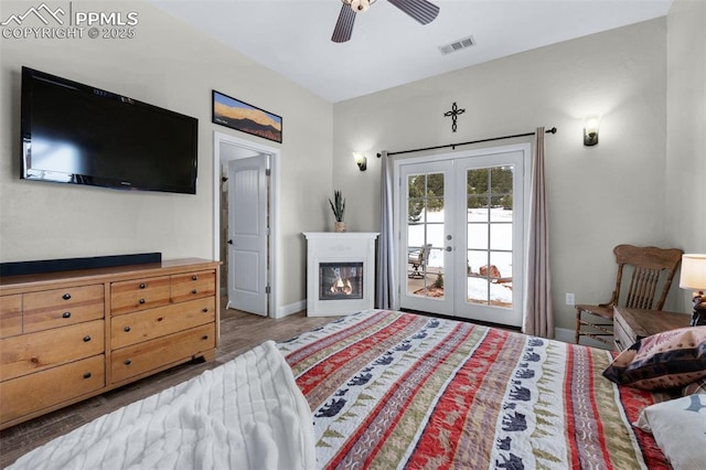 bedroom featuring hardwood / wood-style floors, ceiling fan, access to exterior, and french doors