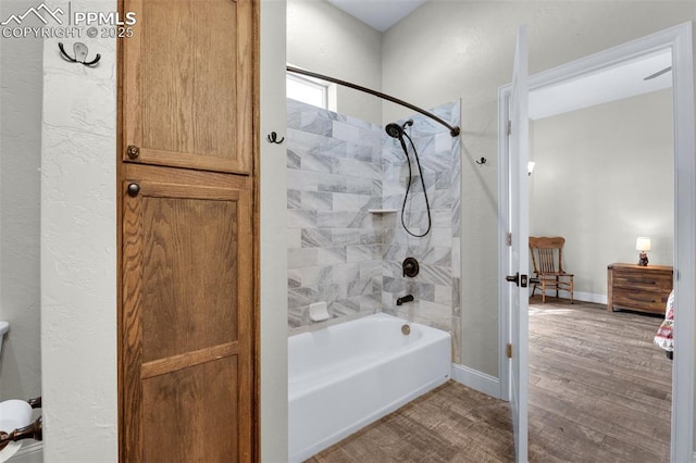 bathroom with tiled shower / bath combo and wood-type flooring