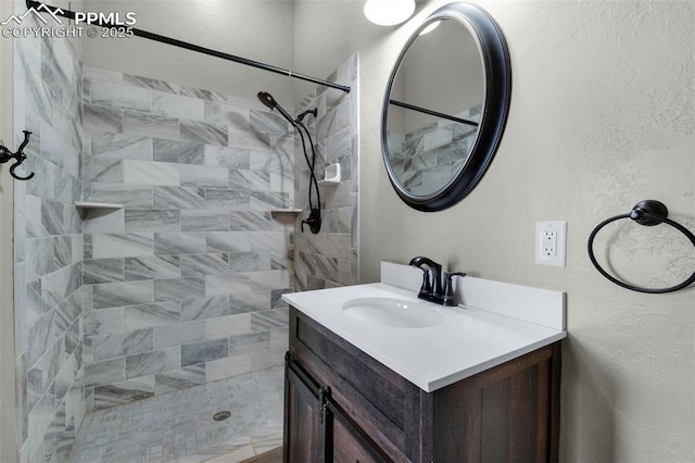 bathroom featuring vanity and a tile shower