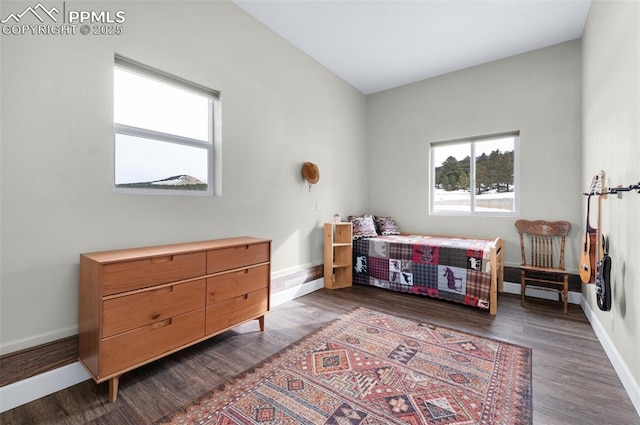 bedroom with dark wood-type flooring