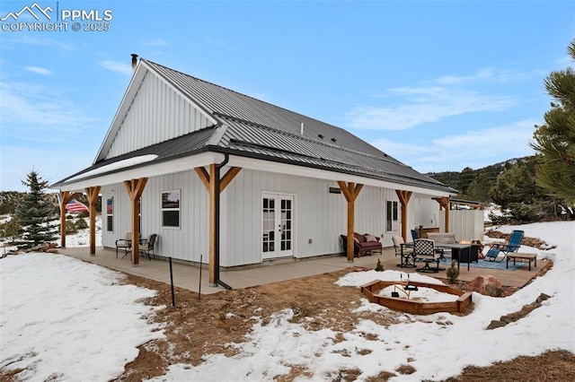 snow covered property featuring french doors