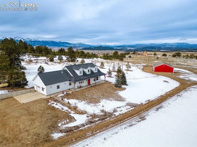 snowy aerial view with a mountain view