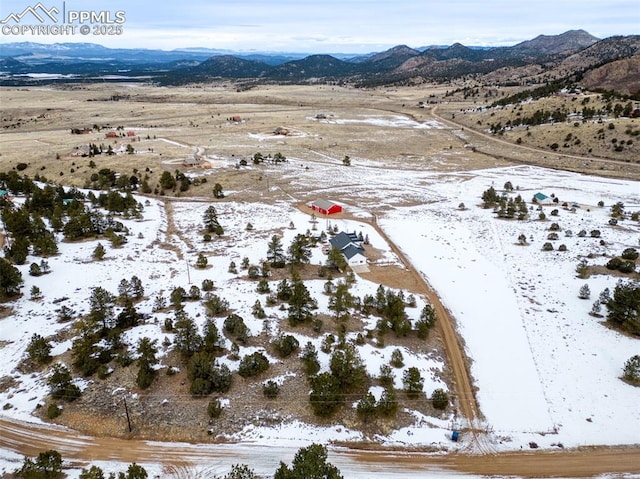 snowy aerial view featuring a mountain view