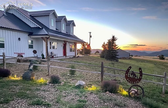 property exterior at dusk with a mountain view