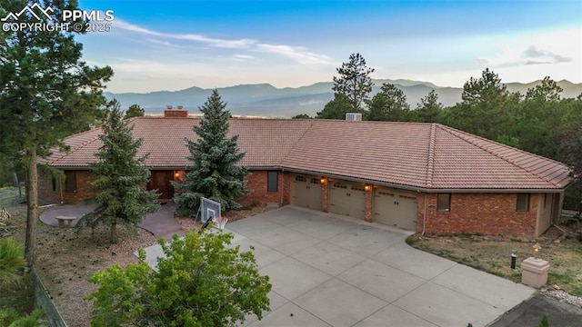 ranch-style home featuring a mountain view and a garage