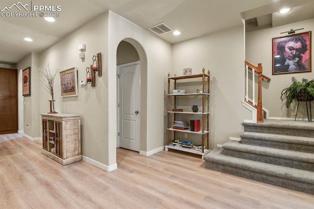 hallway with light hardwood / wood-style floors