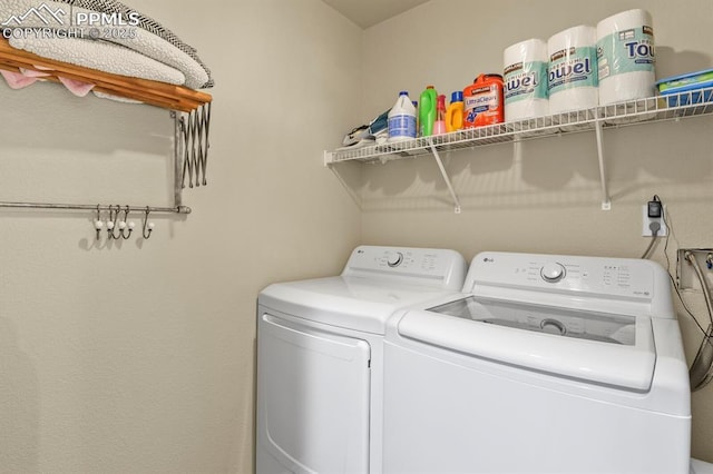 washroom with washing machine and clothes dryer