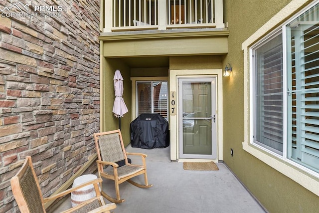 property entrance featuring a patio area and a balcony