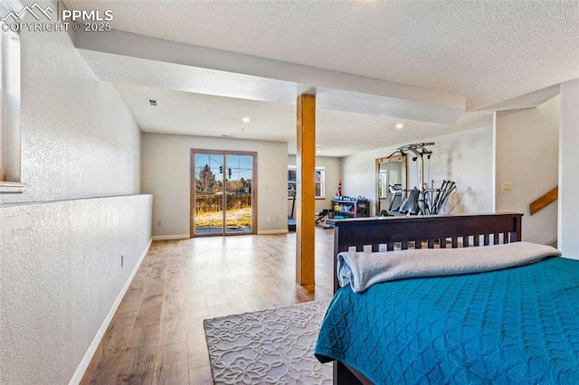 bedroom featuring a textured ceiling and hardwood / wood-style flooring