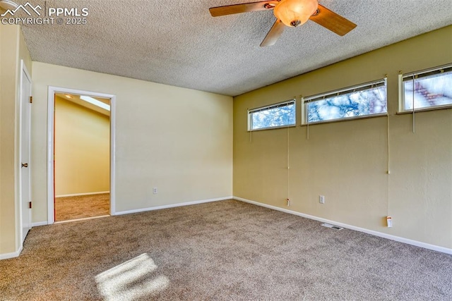 unfurnished room with carpet flooring, a textured ceiling, and ceiling fan