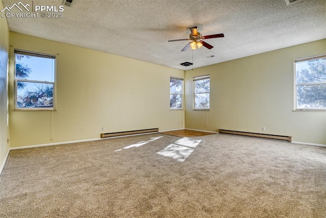 empty room featuring ceiling fan, carpet floors, a textured ceiling, and a baseboard heating unit