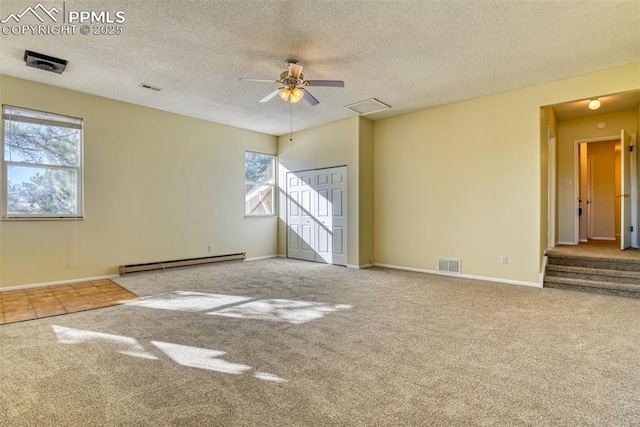 spare room featuring carpet flooring, a textured ceiling, a baseboard radiator, and ceiling fan