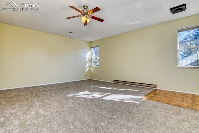 carpeted spare room with a textured ceiling, baseboard heating, and ceiling fan