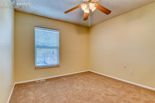 carpeted spare room with ceiling fan and a textured ceiling