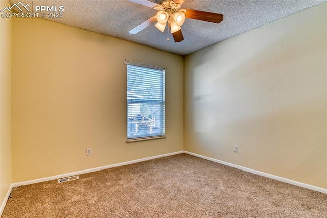 carpeted spare room featuring ceiling fan and a textured ceiling