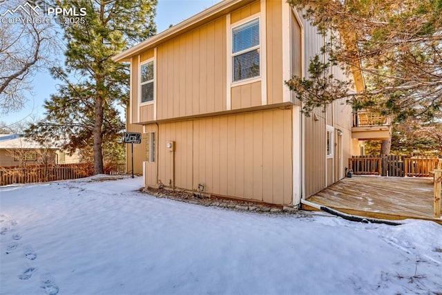 view of snow covered exterior featuring a wooden deck