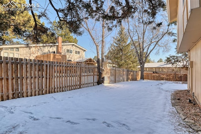 view of yard layered in snow