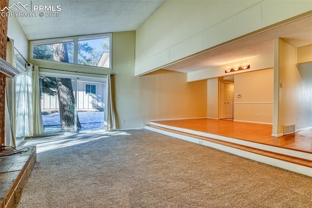 interior space with carpet and high vaulted ceiling