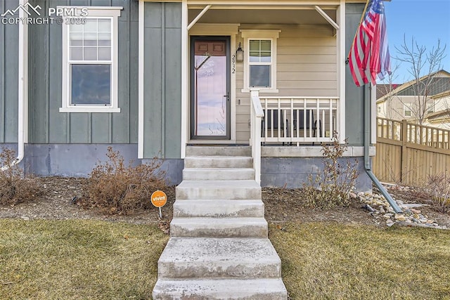 doorway to property with a lawn