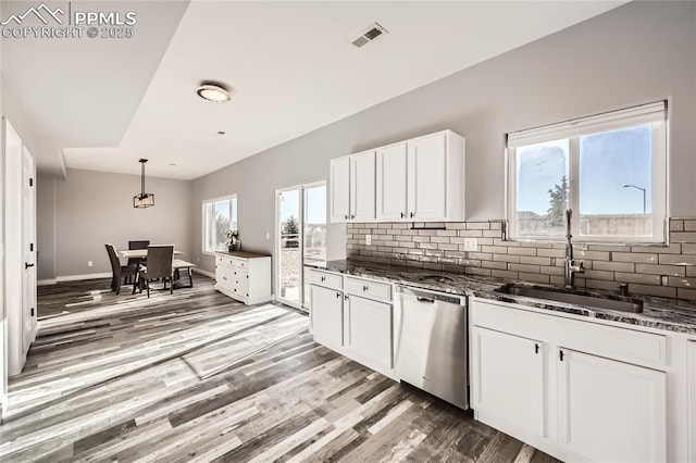 kitchen featuring sink, white cabinetry, dishwasher, and plenty of natural light