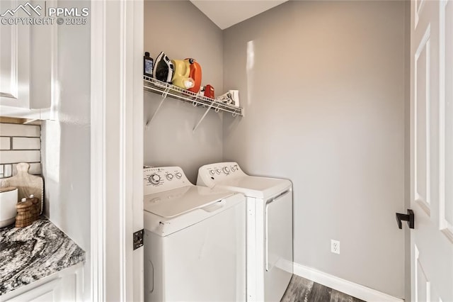 washroom featuring dark hardwood / wood-style flooring and washer and clothes dryer