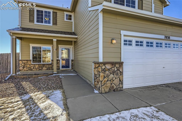 view of exterior entry with a porch and a garage