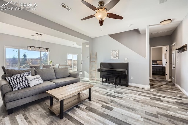 living room with ceiling fan and wood-type flooring