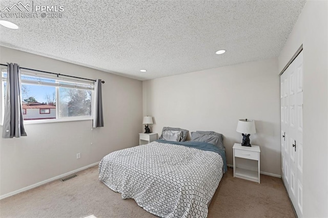 carpeted bedroom featuring a textured ceiling