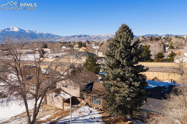 snowy aerial view featuring a mountain view