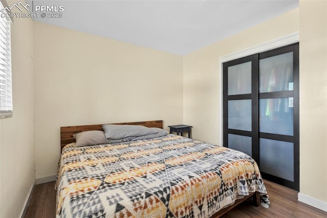 bedroom with dark wood-type flooring