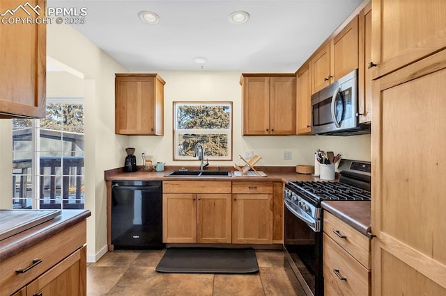 kitchen with dark tile patterned flooring, sink, and appliances with stainless steel finishes