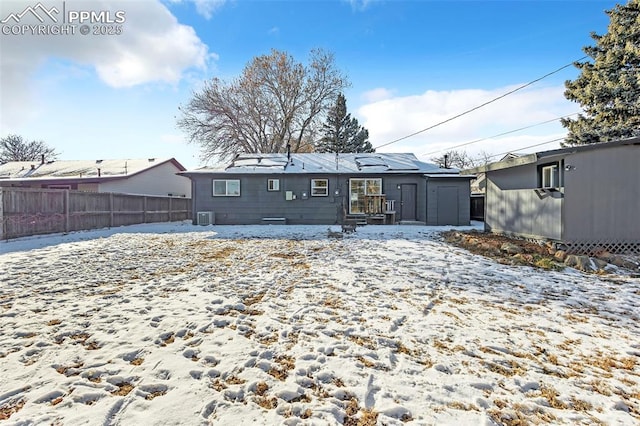 snow covered house with cooling unit