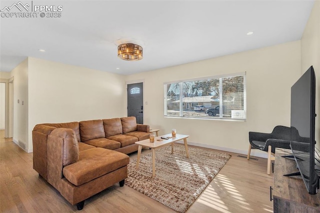 living room with light hardwood / wood-style flooring