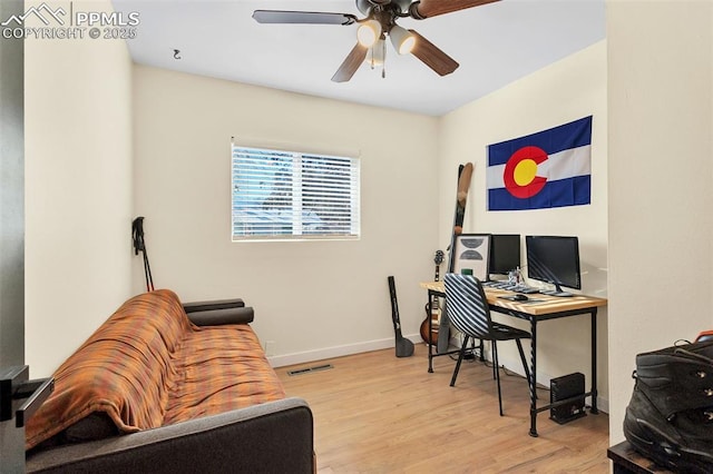 home office with ceiling fan and light wood-type flooring