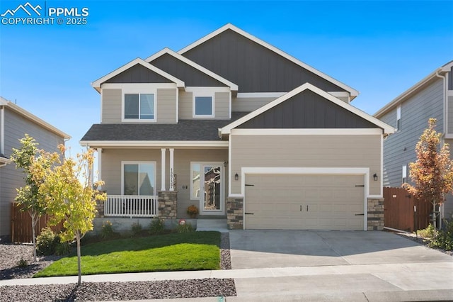 craftsman-style home featuring a front yard, a porch, and a garage