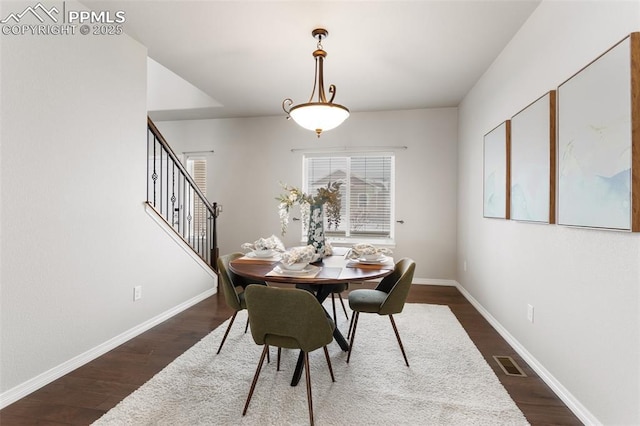 dining space with dark wood-type flooring