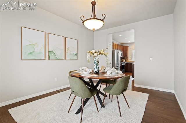 dining space with dark hardwood / wood-style floors