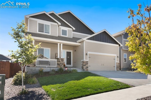 craftsman-style home with a garage, covered porch, and a front lawn